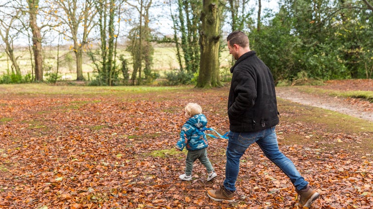 Family enjoying a walk in the grounds at Rufford Old Hall, Lancashire